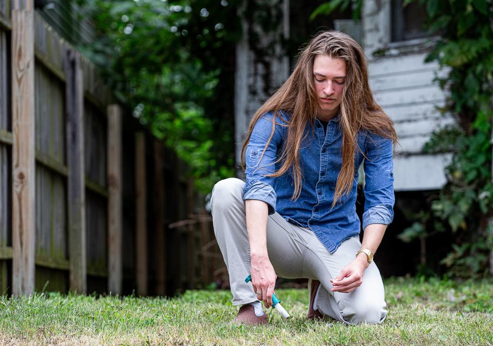 U of L grad student Nicholas Herring took a soil sample from the front yard of a house on W. Kentucky Street in Louisville's California neighborhood to test for the presence of lead paint. Aug. 1, 2023.