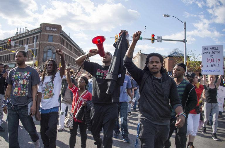 Demonstrators chant on Pennsylvania Avenue in Baltimore, Maryland, April 28, 2015, one day after violence and looting erupted following the funeral of 25-year-old African-American man Freddie Gray, who died in police custody