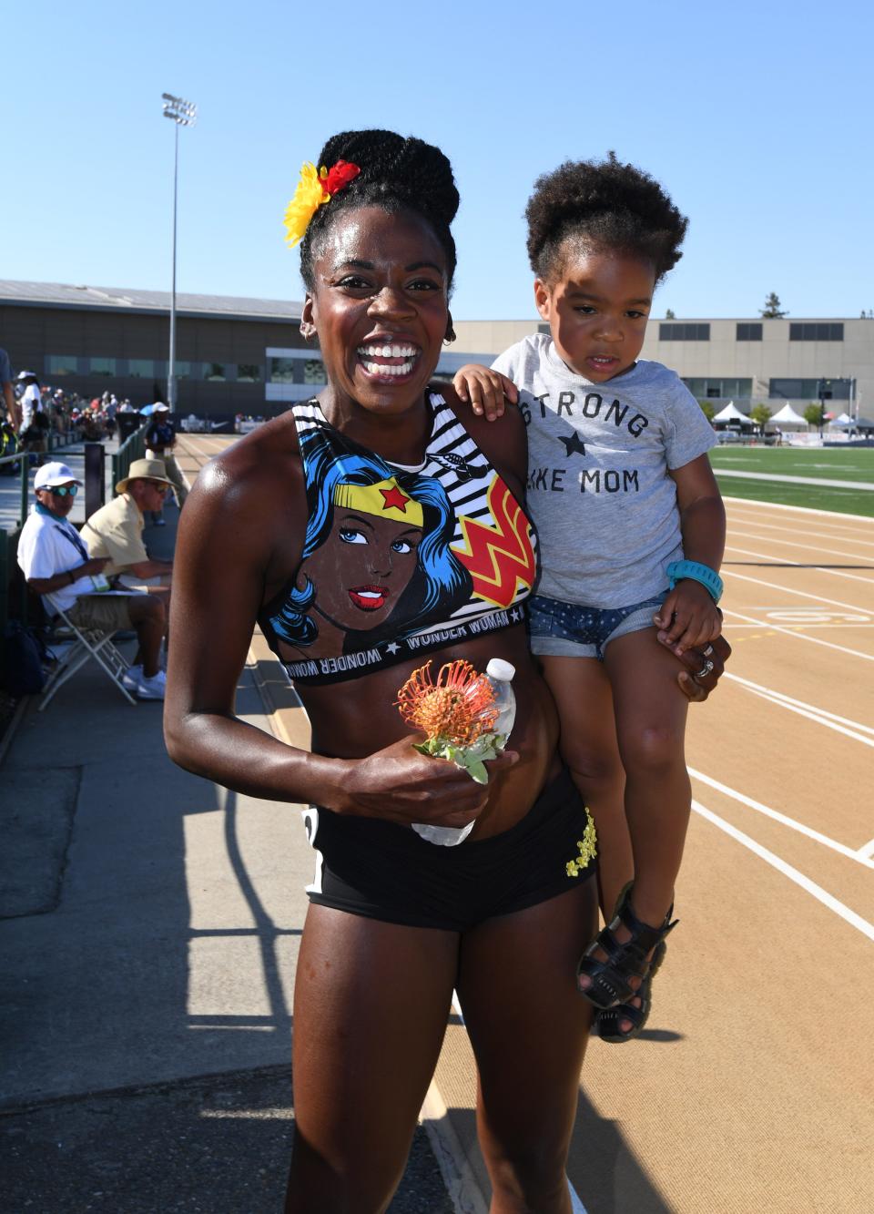 Alysia Montano holds her daughter Linnea Montano after running in a women's 800m heat during the 2017 U.S. Championships while four months pregnant.