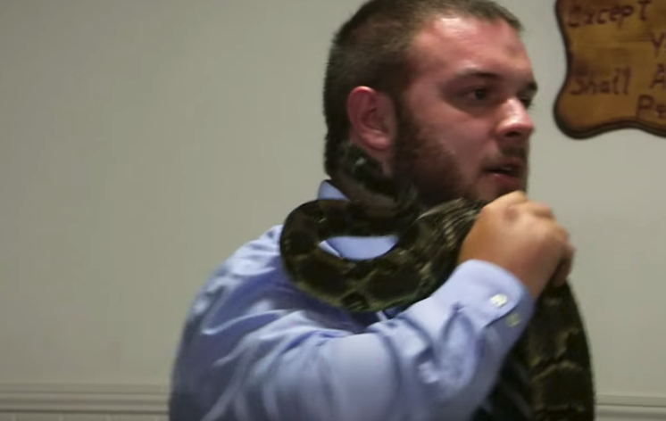 Cody Coots, the pastor at the Full Gospel Tabernacle in Jesus’ Name church in Middlesboro, Ky., is bitten by a snake as he preaches to his congregation. (Photo: YouTube)