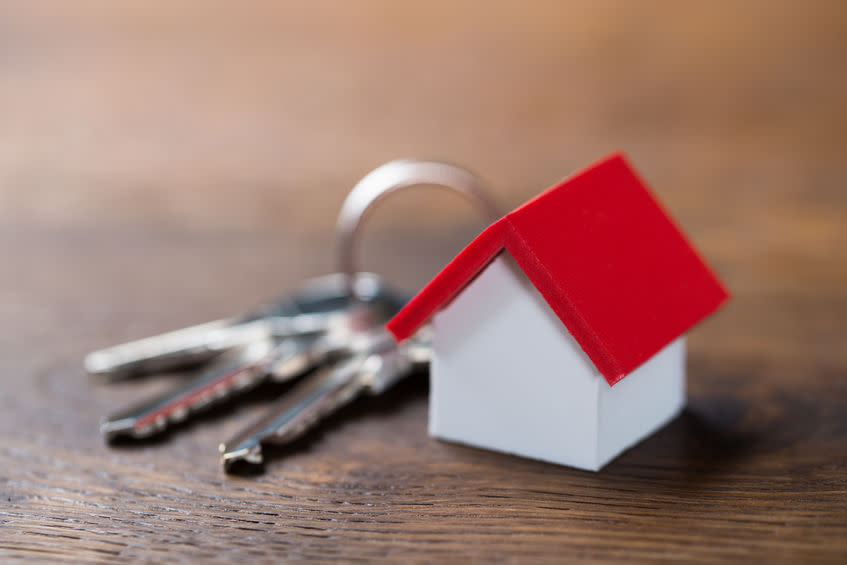 House Model And Keys On Table