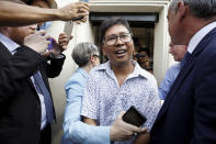 Reuters reporter Wa Lone, center, reacts as he is freed from Insein Prison in Yangon, Myanmar, Tuesday, May 7, 2019. Two Reuters journalists who were imprisoned for breaking Myanmar's Official Secrets Act over reporting on security forces' abuses of Rohingya Muslims were pardoned and released Tuesday, the prison chief and witnesses said. (Ann Wang/Pool Photo via AP)