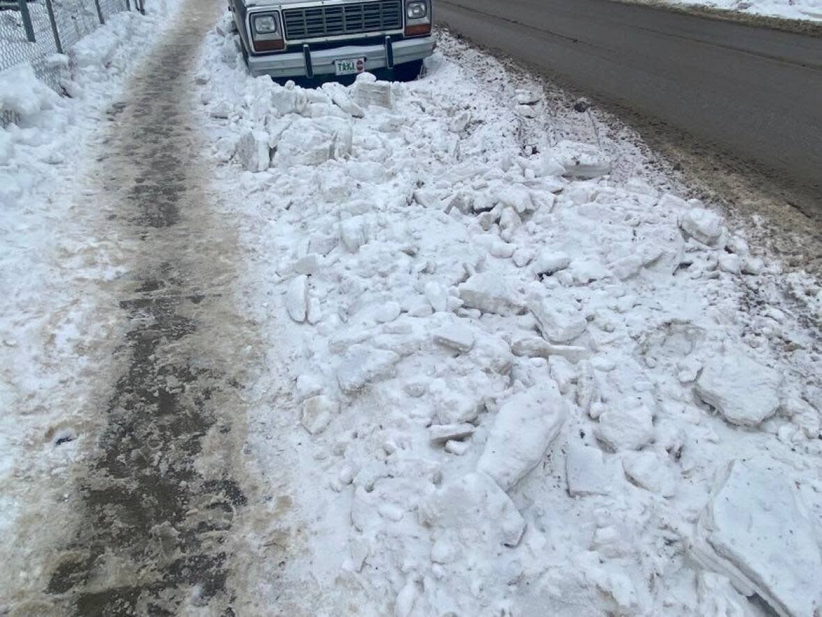 Al Bodnarchuk says that after the city removed the snow, it was left piled in his yard and in the street around his truck. (Submitted by Al Bodnarchuk - image credit)