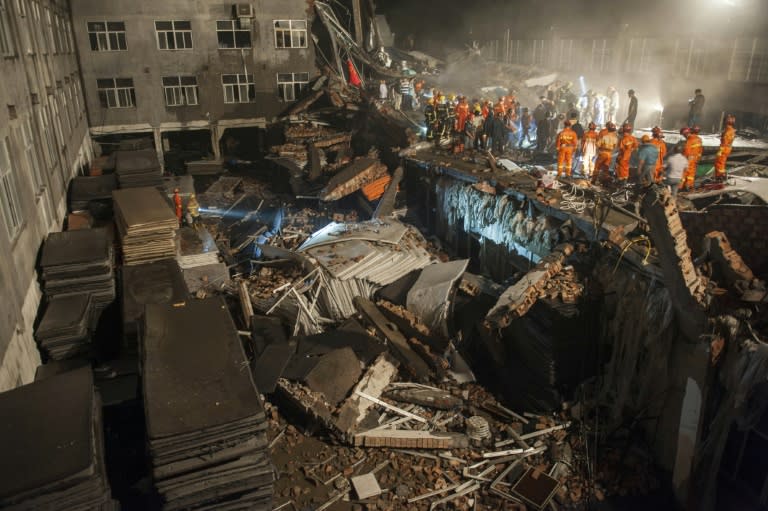 Rescuers look for survivors in the debris of a collapsed building in Wenling, in eastern China's Zhejiang province, on July 4, 2015