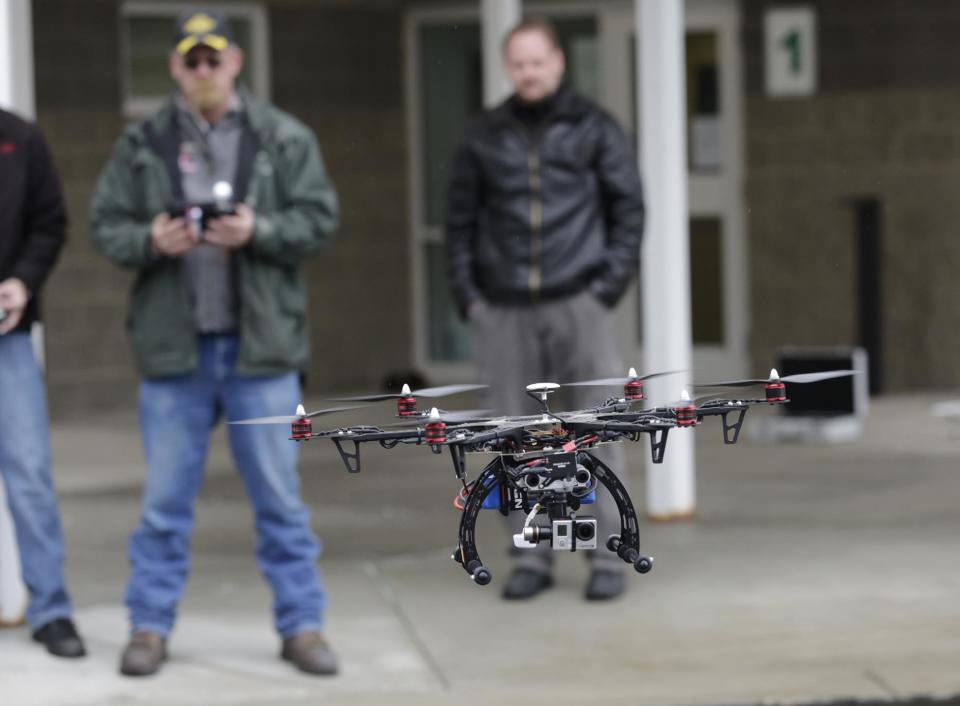 In this Feb. 13, 2014, photo, members of the Box Elder County Sheriff's Office search and rescue team fly their search and rescue drone during a demonstration, in Brigham City, Utah. Law enforcement, government agencies and others are itching to use drones for everything from finding lost hikers to tracking shifting wildfires. But privacy watchdogs are urging state legislatures to step in and head off any potential privacy violations. That tension is on display as more than 35 states consider drone legislation this year, according to the National Conference of State Legislatures. The bills include ways to attract an industry that could generate billions and restrictions on drone use and data collection. (AP Photo/Rick Bowmer)