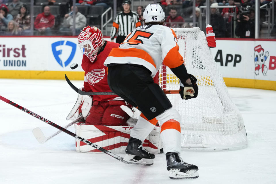 Detroit Red Wings goaltender Ville Husso (35) stops a Philadelphia Flyers defenseman Cam York (45) shot in the second period of an NHL hockey game Saturday, Jan. 21, 2023, in Detroit. (AP Photo/Paul Sancya)