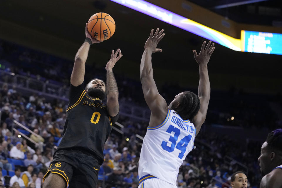 Long Beach State guard Marcus Tsohonis (0) shoots over UCLA guard David Singleton (34) during the first half of an NCAA college basketball game Friday, Nov. 11, 2022, in Los Angeles. (AP Photo/Marcio Jose Sanchez)
