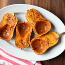 <p>Honeynut squash looks just like mini butternut squash, but on the inside you'll find an even sweeter, deeper orange flesh. This winter squash has only been available at farmers' markets and in select grocery stores for a few years. If you see it, grab a few to try! This simple roasting method enhances the natural flavor of the squash with butter and spices. <a href="https://www.eatingwell.com/recipe/268480/roasted-honeynut-squash/" rel="nofollow noopener" target="_blank" data-ylk="slk:View Recipe;elm:context_link;itc:0;sec:content-canvas" class="link ">View Recipe</a></p>