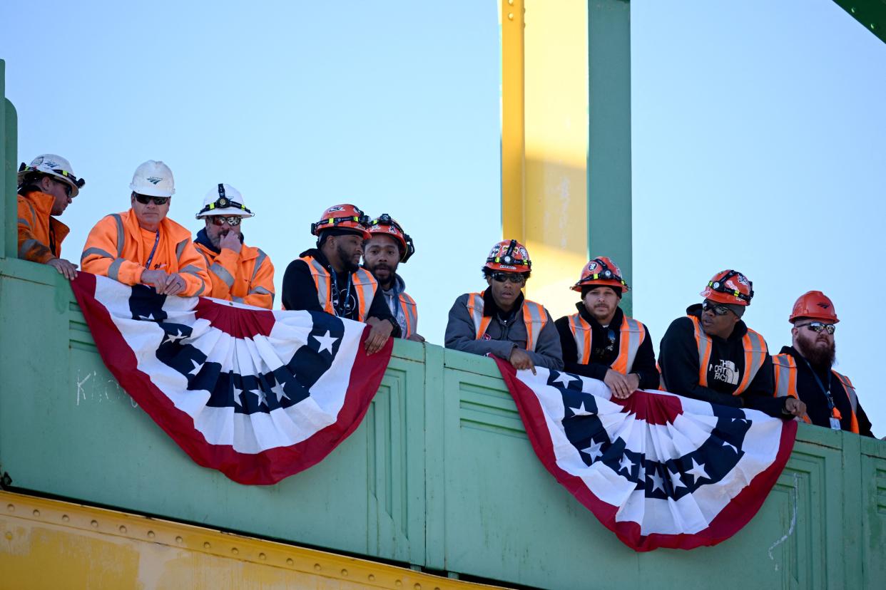 Workers watch as US President Joe Biden, not pictured, delivers remarks on the Bipartisan Infratructure Law at the Baltimore and Potomac Tunnel North Portal in Baltimore, Maryland, on January 30, 2023. (Photo by Mandel NGAN / AFP) (Photo by MANDEL NGAN/AFP via Getty Images)