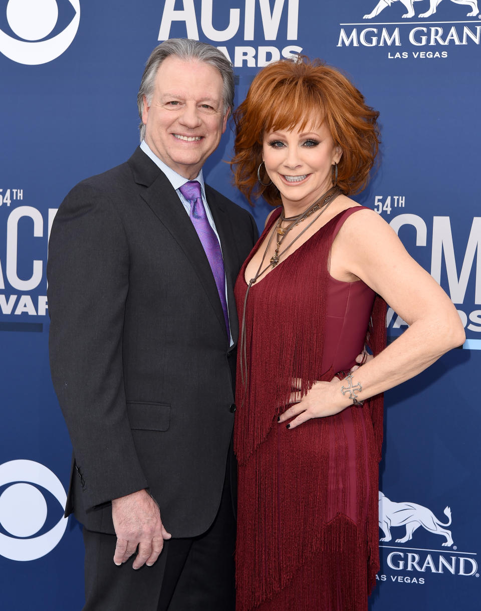 Two individuals posing together at the ACM Awards event