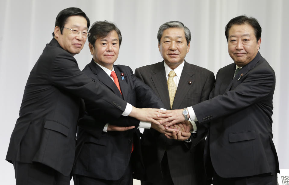 Japanese Prime Minister Yoshihiko Noda, right, puts hands together with former Agriculture, Forestry and Fisheries Minister Michihiko Kano, left, former Internal Affairs and Communications Minister Kazuhiro Haraguchi, second left, and former Agriculture, Forestry and Fisheries Minister Hirotaka Akamatsu during a joint press conference by candidates of presidential election of Japan’s ruling Democratic Party of Japan in Tokyo Monday, Sept. 10, 2012. Noda will face three ruling party contenders in a leadership election later this month that he is expected to win. (AP Photo/Shizuo Kambayashi)