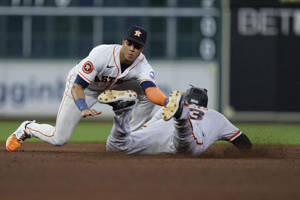 Houston Astros shortstop Jeremy Pena (3) catches San Francisco Giants pinch runner Austin Slater trying to steal second base during the eighth inning of a baseball game, Tuesday, May 2, 2023, in Houston. (AP Photo/Kevin M. Cox)