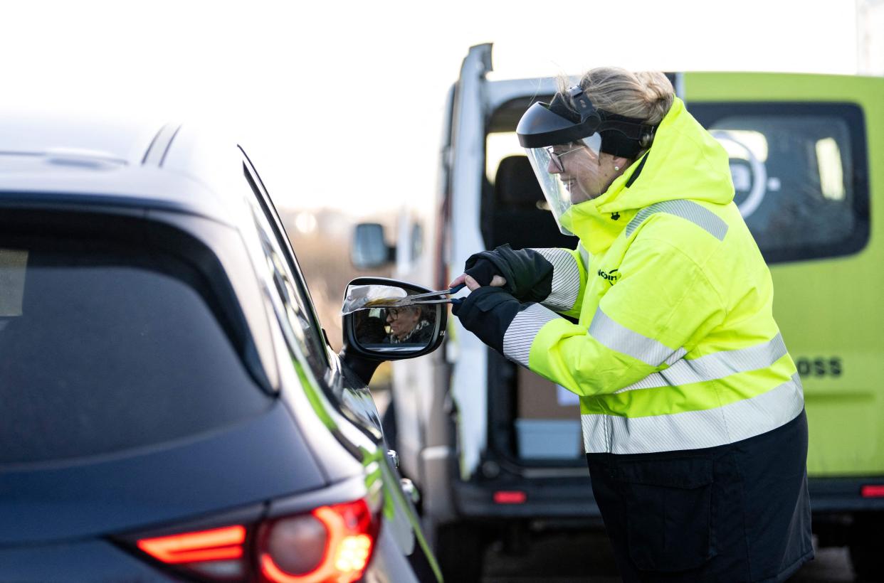 A staff member collects the last Covid-19 PCR tests at the Covid testing site of Svagertorp in Malmo, Sweden, on Feb. 8, 2022.