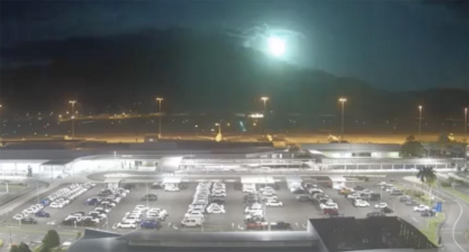 A meteor lights up the sky over Cairns Airport.