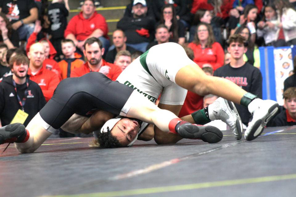 Lowell's Carter Cichocki, left, readies to pin Freeland's Malachi Hill in the 120-pound division in the MHSAA individual wrestling finals on Saturday, Feb. 24, 2024, in Kalamazoo.