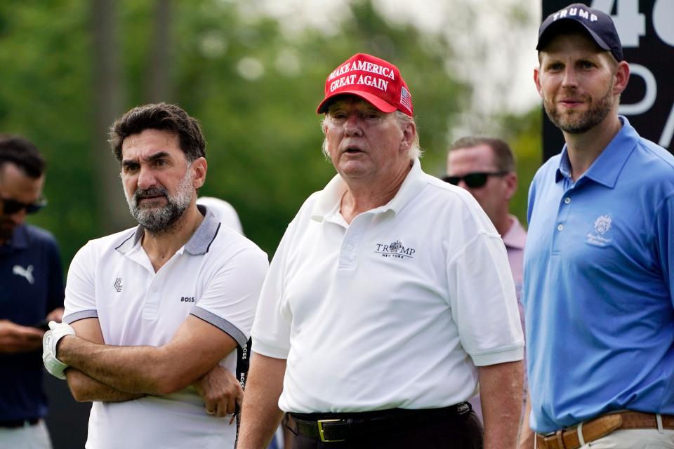 Former President Trump stands with his son Eric and Yasir Al-Rumayyan, left, a governor of Saudi Arabia's Public Investment Fund.