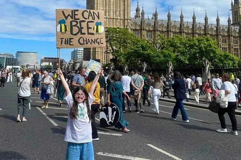 Seren Studholme outside Big Ben at the Restore Nature Now protest in London