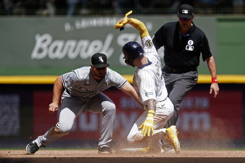 Milwaukee Brewers' Joey Ortiz, center, is tagged out by Chicago White Sox's Paul DeJong, left, while attempting to steal second base during the sixth inning of a baseball game Sunday, June 2, 2024, in Milwaukee. (AP Photo/Aaron Gash)