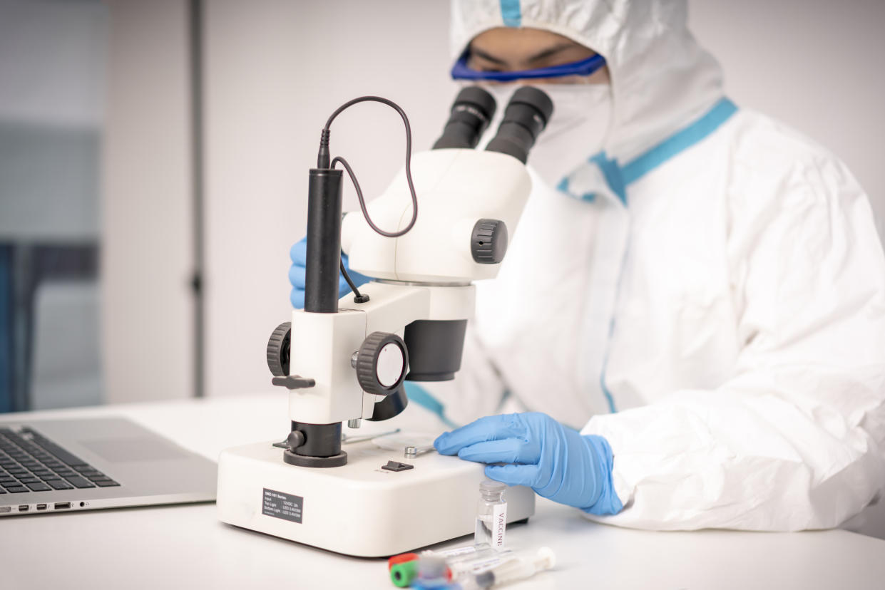 A doctor in protective clothing examines the Novel Coronavirus vaccine