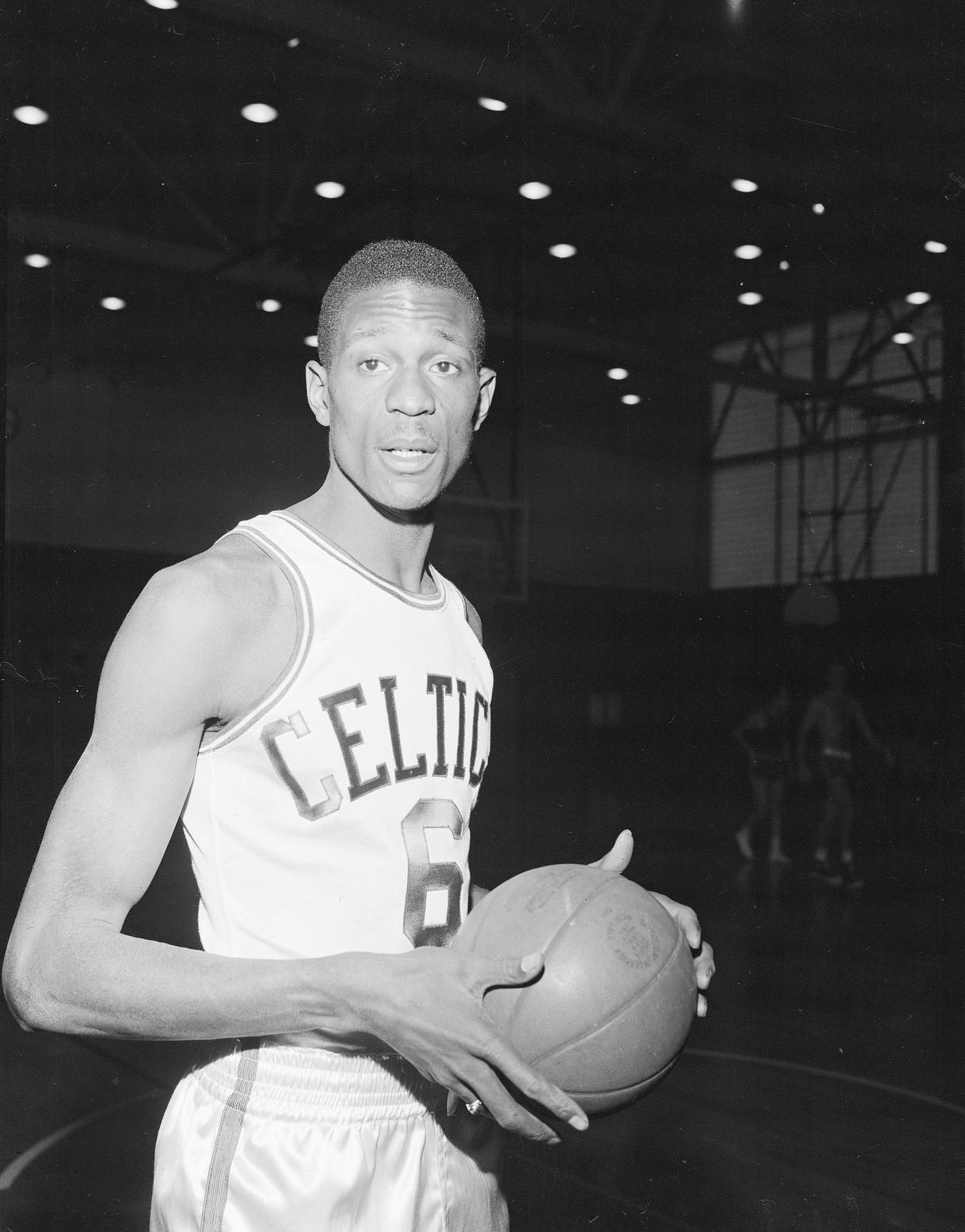 Bill Russell of San Francisco and the Olympic basketball team wears a Boston Celtics uniform for his first workout with the NBA team shortly after having signed a contract in Boston on Dec. 19, 1956. (AP file)