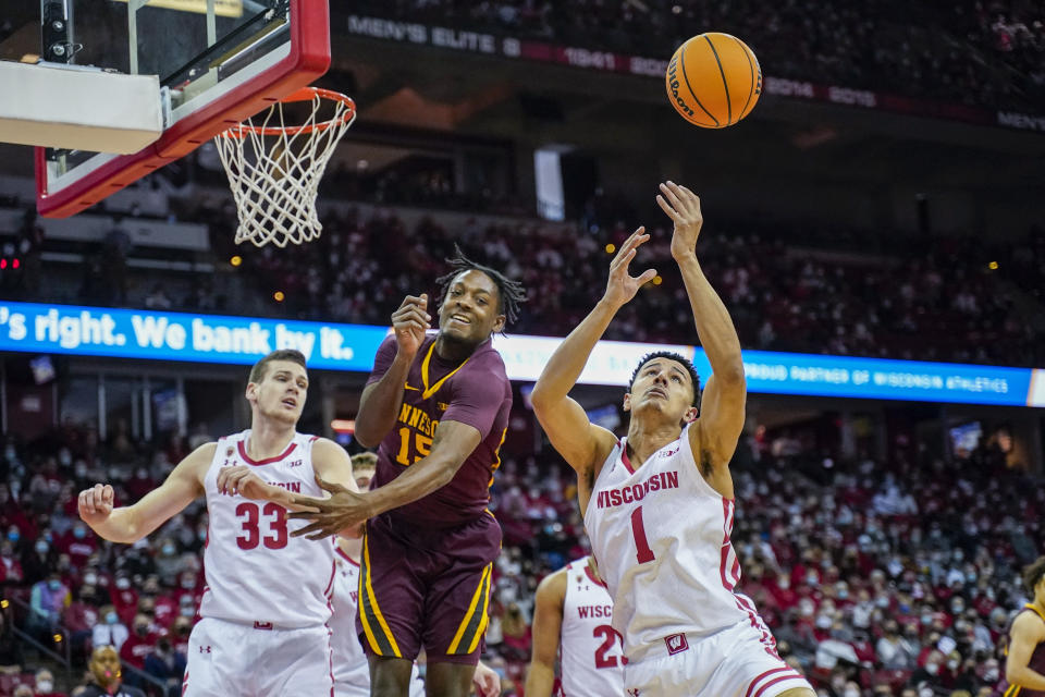 Wisconsin's Johnny Davis (1) grabs a defensive rebound against Minnesota's Charlie Daniels (15) during the first half of an NCAA college basketball game Sunday, Jan. 30, 2022, in Madison, Wis. (AP Photo/Andy Manis)