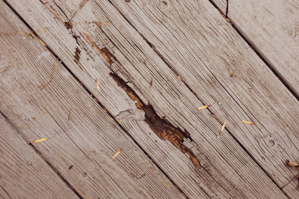 rotting wood on outdoor patio deck in need of repair