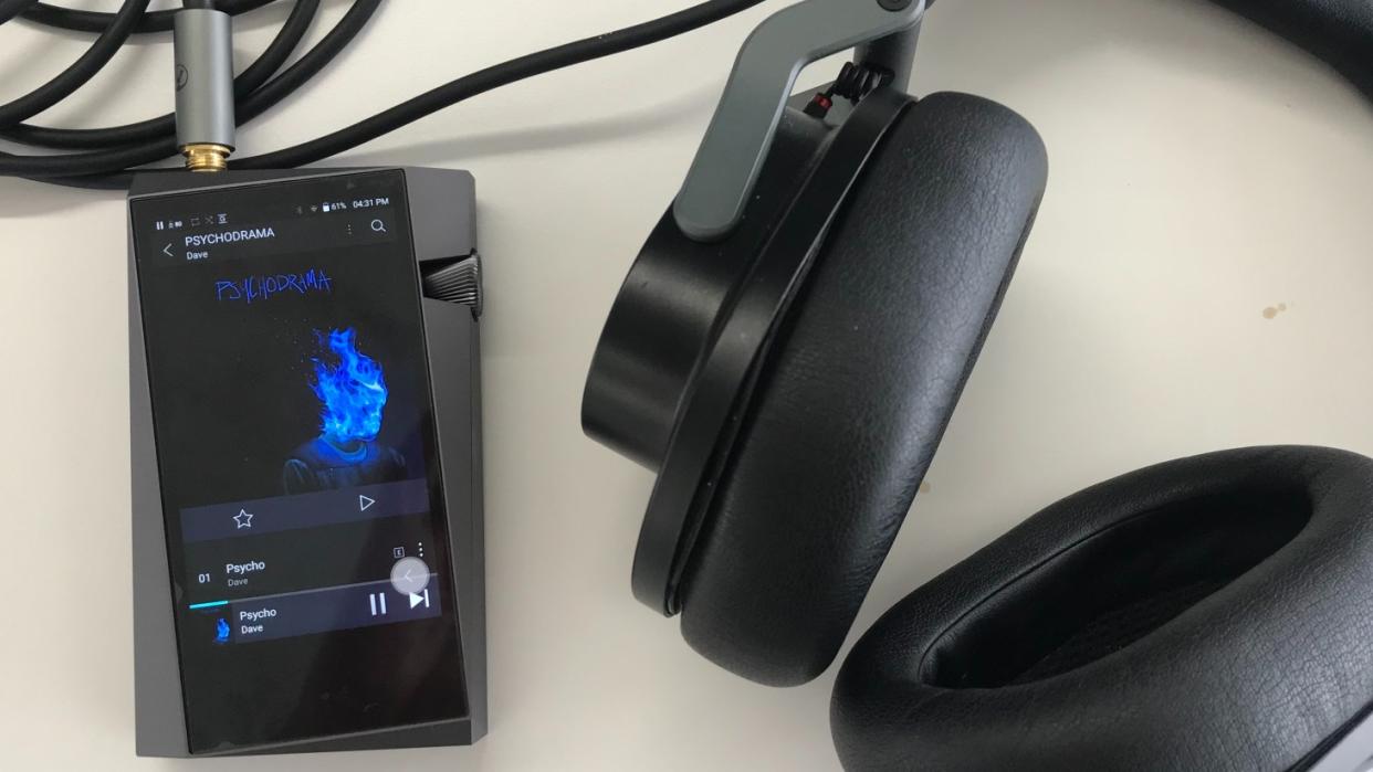  Astell & Kern A&norma SR25 MKII next to Austrian Audio headphones on a white background. 