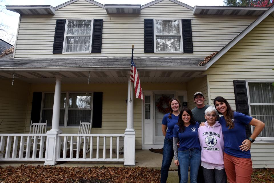 Cecilia Bodine (center) takes a break from packing and organizing to pose in front of her Granville home with Songbird Transitions Tabi Amos, Zach Dobbelaer, Jackie Wright, and Samantha Stearns. Songbird Transitions helps clients who are downsizing their homes. Many items are donated to organizations such as Fostering Further.