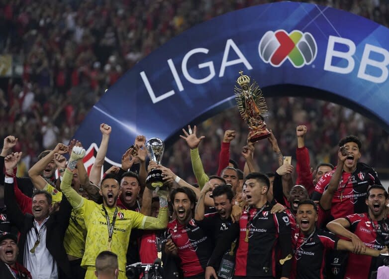 Mexico's Atlas players lift the trophy after winning the Mexican soccer league final match against Mexico's Leon in Guadalajara, Sunday, Dec. 12, 2021. (AP Photo/Eduardo Verdugo)