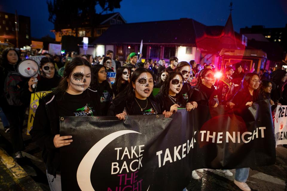 Members of Muxeres lead the Take Back the Night march in Eugene on Thursday, their faces half painted to commemorate those lost to femicide, while the unpainted half offers support for survivors of sexual assault.