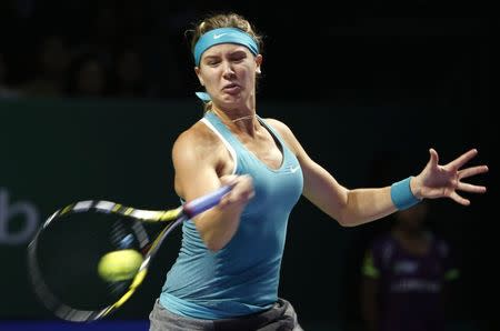 Eugenie Bouchard of Canada hits a return to Serena Williams of the U.S. during their WTA Finals singles tennis match at the Singapore Indoor Stadium October 23, 2014. REUTERS/Edgar Su