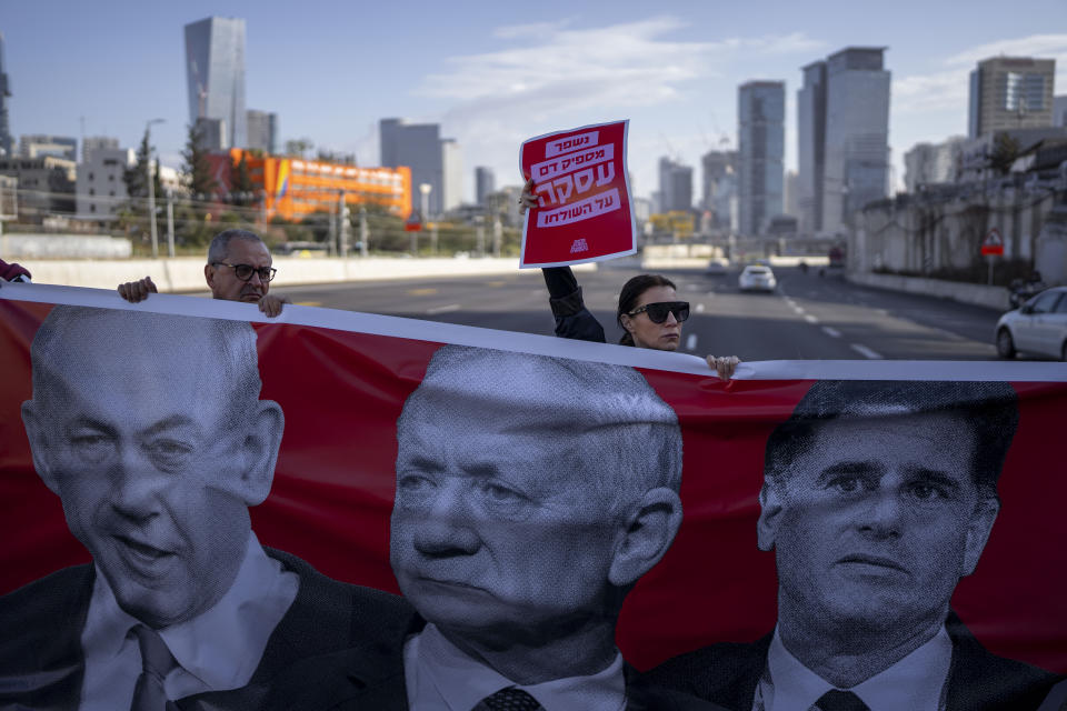 Activists block a highway as they demand the release of the hostages from Hamas captivity in the Gaza Strip, in Tel Aviv, Israel, Wednesday, March 20, 2024. (AP Photo/Oded Balilty)