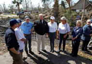 U.S. President Donald Trump and first lady Melania Trump talk with FEMA Director Brock Long, a local resident, Florida Governor Rick Scott, Lynn Haven Mayor Margo Anderson and Department of Homeland Security Secretary Kirstjen Nielsen as they tour areas ravaged by Hurricane Michael in Lynn Haven, Florida, U.S., October 15, 2018. REUTERS/Kevin Lamarque