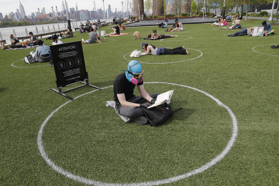 Ridley Goodside wears a rubber diving head covering along with goggles and a special air filtration mask in Domino Park. (Photo: ASSOCIATED PRESS)