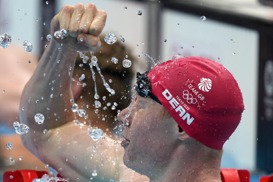 Tom Dean of Britain celebrates after winning the final of the men's 200-meter freestyle at the 2020 Summer Olympics, Tuesday, July 27, 2021, in Tokyo, Japan. (AP Photo/Martin Meissner)