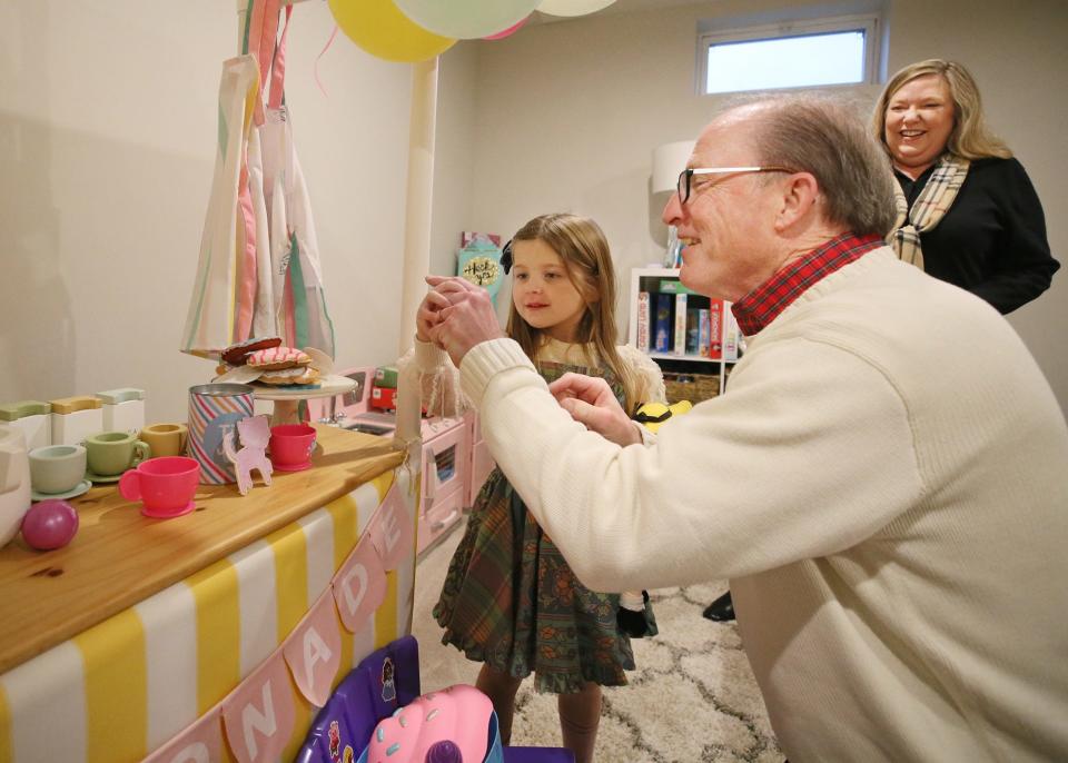 LJ Horvath, 5, stops Rich Wilson from pretending to eat a cake as his wife, Lara, watches in the playroom at the her family’s Lafayette Township home.