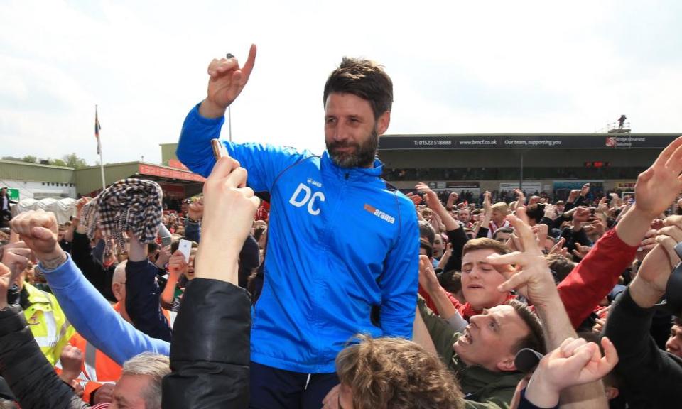 Lincoln City supporters lift up Danny Cowley after the win against Macclesfield that sealed promotion back to the Football League on 22 April 2017