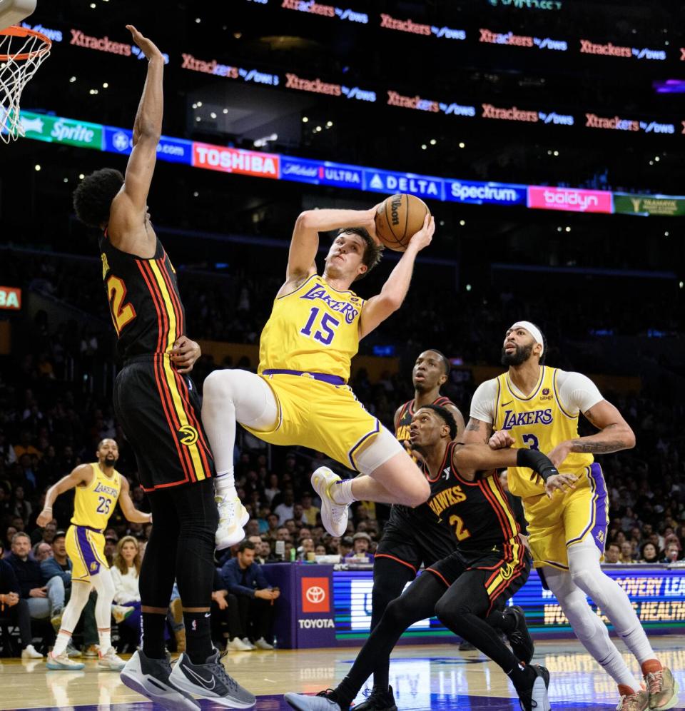 Austin Reaves makes a midair pass.