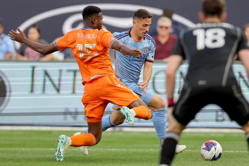 May 31, 2023;  New York, New York, USA;  New York City FC defender Brian Cufre (3) controls the ball against FC Cincinnati defender Yerson Mosquera (15) and goalkeeper Roman Celentano (18) during the first half at Yankee Stadium.