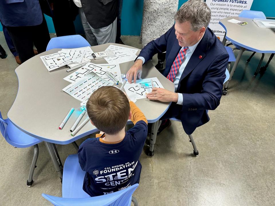 Knox County Commissioner Larsen Jay and children interact with new STEM-focused games at the South Knoxville Boys & Girls Vestal Club on Jan. 26, 2024.