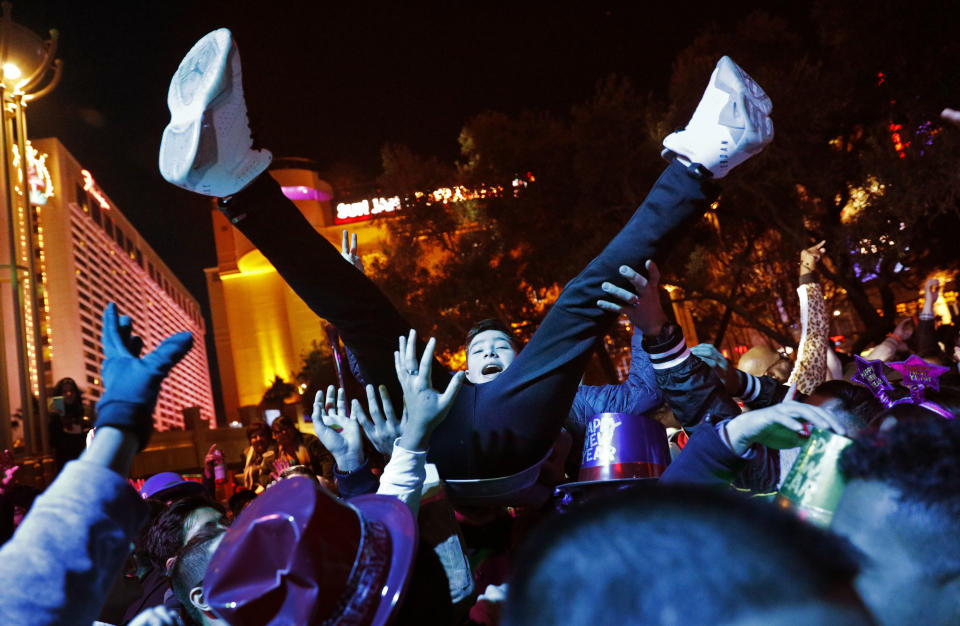 Revellers dance at Caesars Palace along the Las Vegas Strip during a new year's celebration