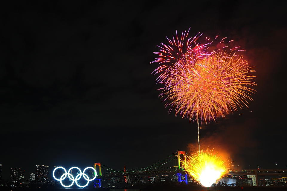 TOKYO, JAPAN - JANUARY 24: Fireworks explode as Olympic rings are illuminated for the first time to mark 6 months to go to the Olympic games at Odaiba Marine Park on January 24, 2020 in Tokyo, Japan. (Photo by David Mareuil/Anadolu Agency via Getty Images)