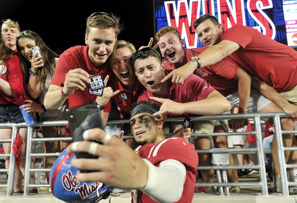 Matt Corral celebrates with fans after defeating Arkansas in 2019.