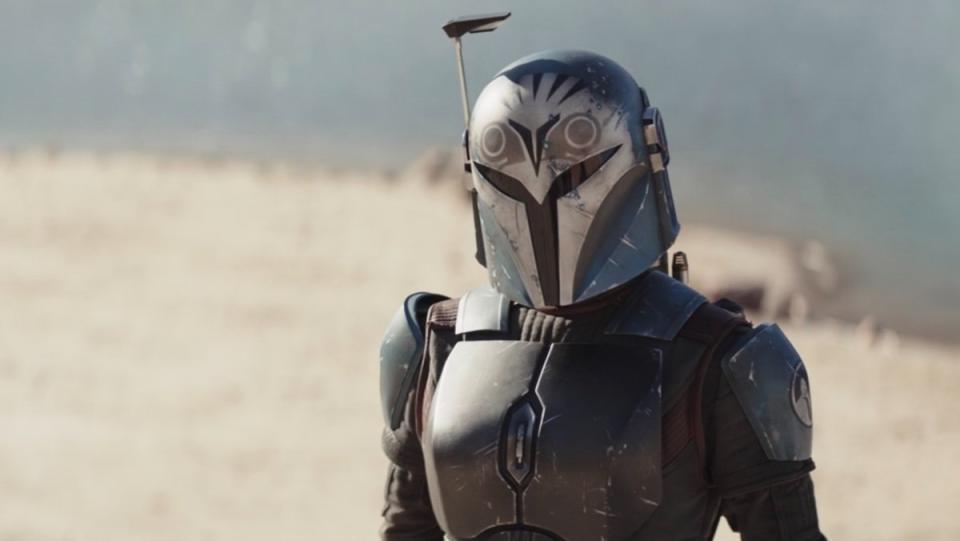 Bo-Katan in her helmet speaks to the Watch from a beach on The Mandalorian