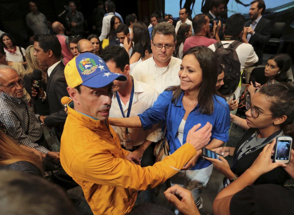 FILE - Opposition leaders Henrique Capriles, left, and Maria Corina Machado talk after a meeting where the opposition decided to plan a symbolic referendum in Caracas, Venezuela, Monday, July 3, 2017. Capriles and Machado have been restricted from running for office. (AP Photo/Fernando Llano, File)