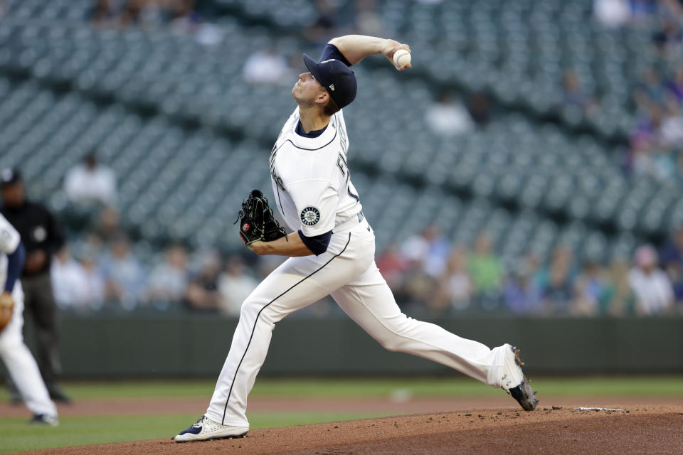 Seattle Mariners starting pitcher Chris Flexen works against the Colorado Rockies during the first inning of a baseball game, Tuesday, June 22, 2021, in Seattle. (AP Photo/John Froschauer)