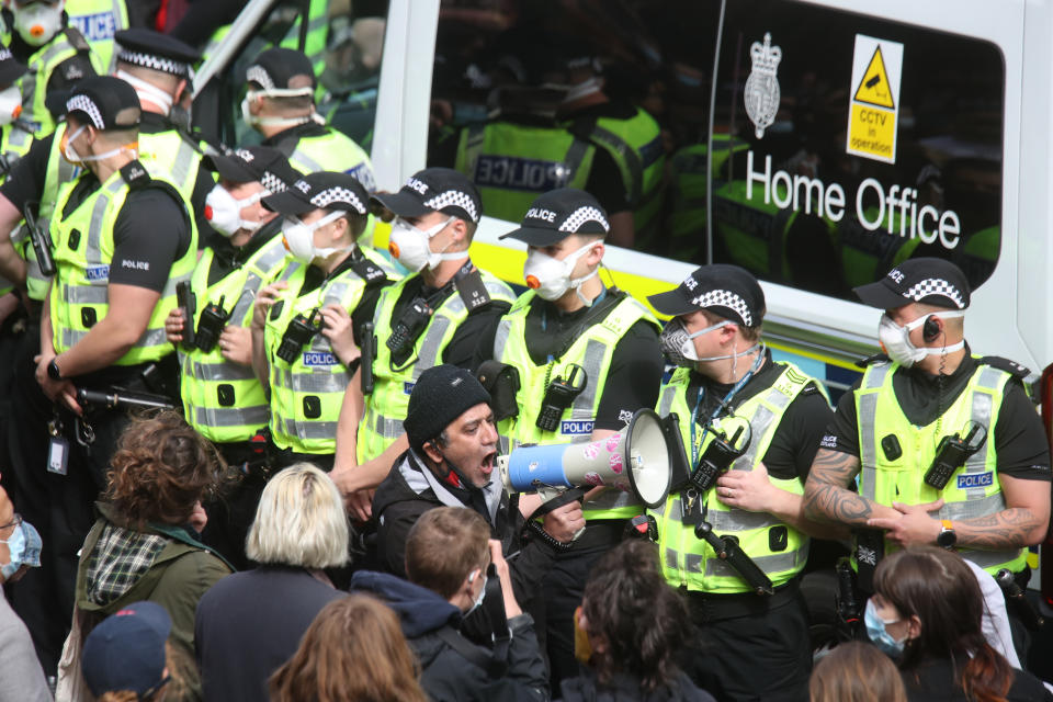 <p>Police by an immigration van in Kenmure Street, Glasgow which is surrounded by protesters. Picture date: Thursday May 13, 2021.</p>
