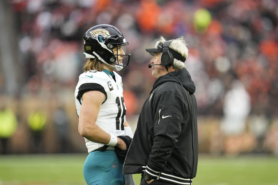 Jacksonville Jaguars quarterback Trevor Lawrence (16) talks with head coach Doug Pederson during the second half of an NFL football game against the Cleveland Browns, Sunday, Dec. 10, 2023, in Cleveland. (AP Photo/Sue Ogrocki)