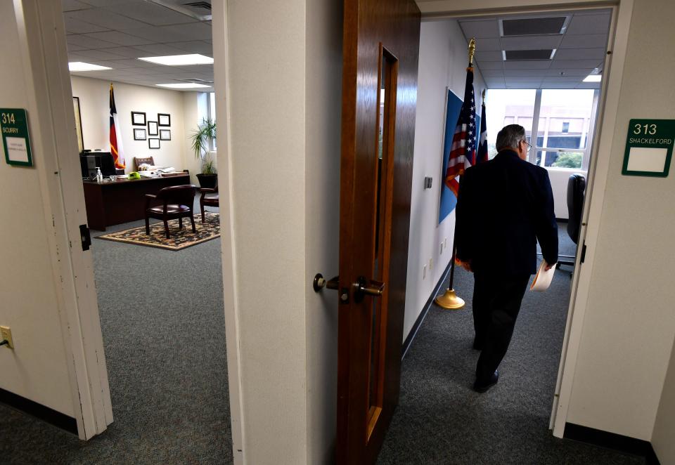 Judge Downing Bolls enters the commissioners court located next door to his office at the Taylor County Plaza Dec. 6. The usual meeting place for the court, the old Taylor County Courthouse, is still under restoration.