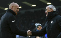 Burnley manager Sean Dyche, left, greets Fulham manager Claudio Ranieri during the English Premier League soccer match between Burnley F.C and Fulham at the Turf Moor stadium, Burnley, England. Saturday, Jan. 12, 2019. (Dave Thompson/PA via AP)